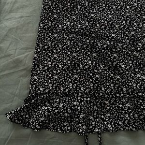 Black mini skirt with white flowers print.